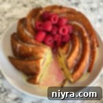 Overhead of lemon raspberry bundt cake on a white plate