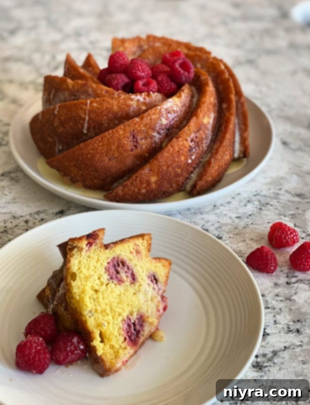 Close-up of a bundt cake slice with raspberries