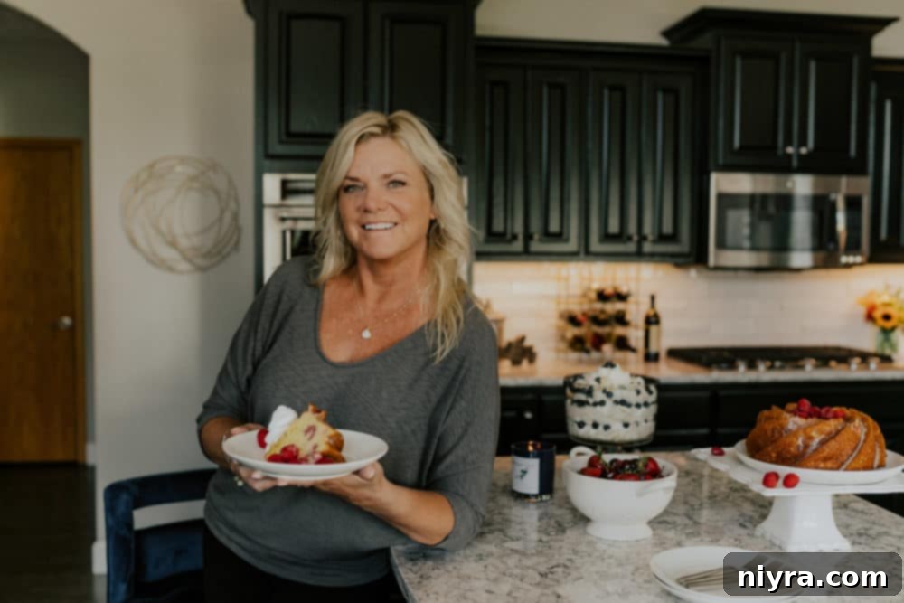Professional shot of a baker decorating the Lemon Raspberry Bundt Cake