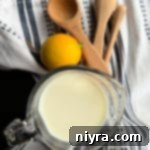 Buttermilk Backups 11 Buttermilk Substitute image with milk and lemon and measuring spoons