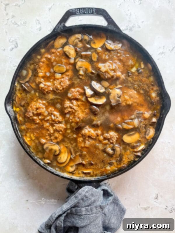 Mushroom Smothered Salisbury Steak 12 Gravy Thickening in a Skillet with Mushrooms