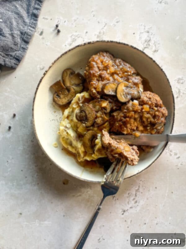 Mushroom Smothered Salisbury Steak 3 Close-up of Salisbury Steak patty with gravy
