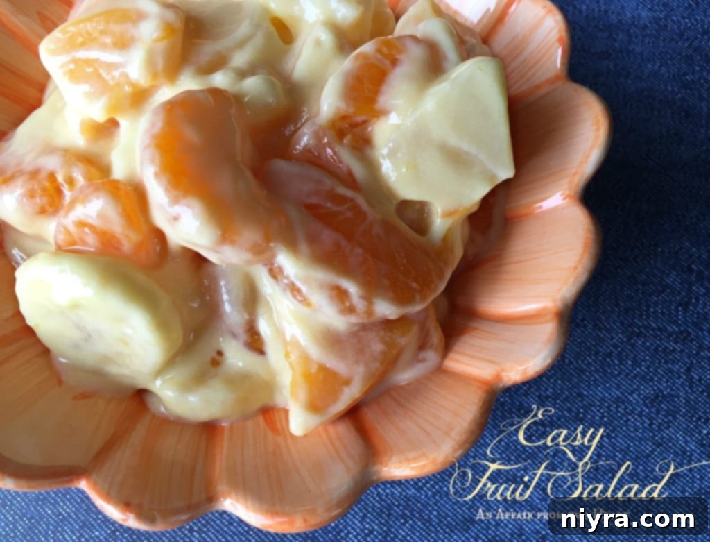 easy fruit salad in a coral serving bowl, close up of the fruit texture