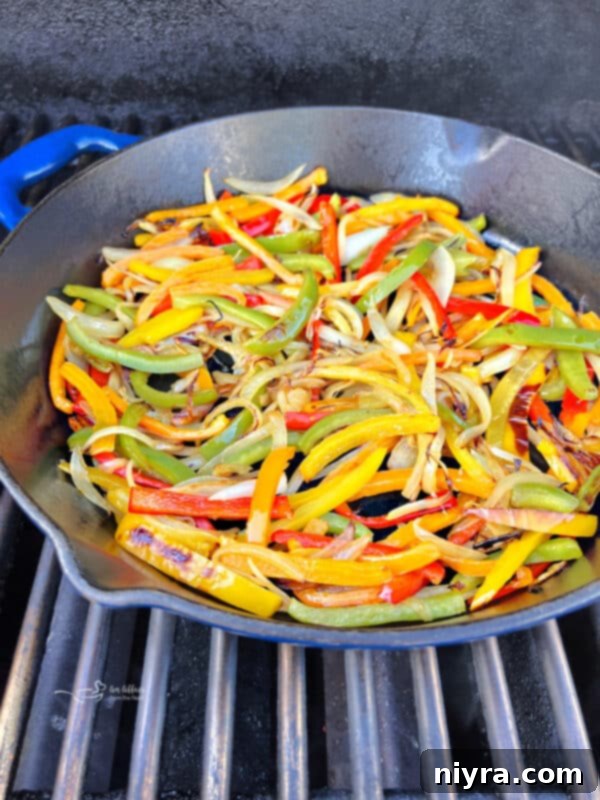 Seasoning being sprinkled on peppers and onions