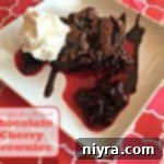 chocolate cherry brownie on a white plate with text "Chocolate Cherry Brownies"