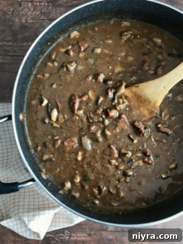 Thick, rich beef gravy coating the beef tips, ready to be served.