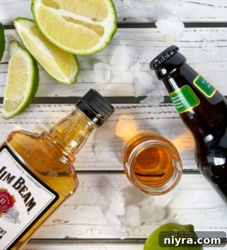 Ingredients laid out for making a Kentucky Mule: bourbon, ginger beer, limes, and an orange.