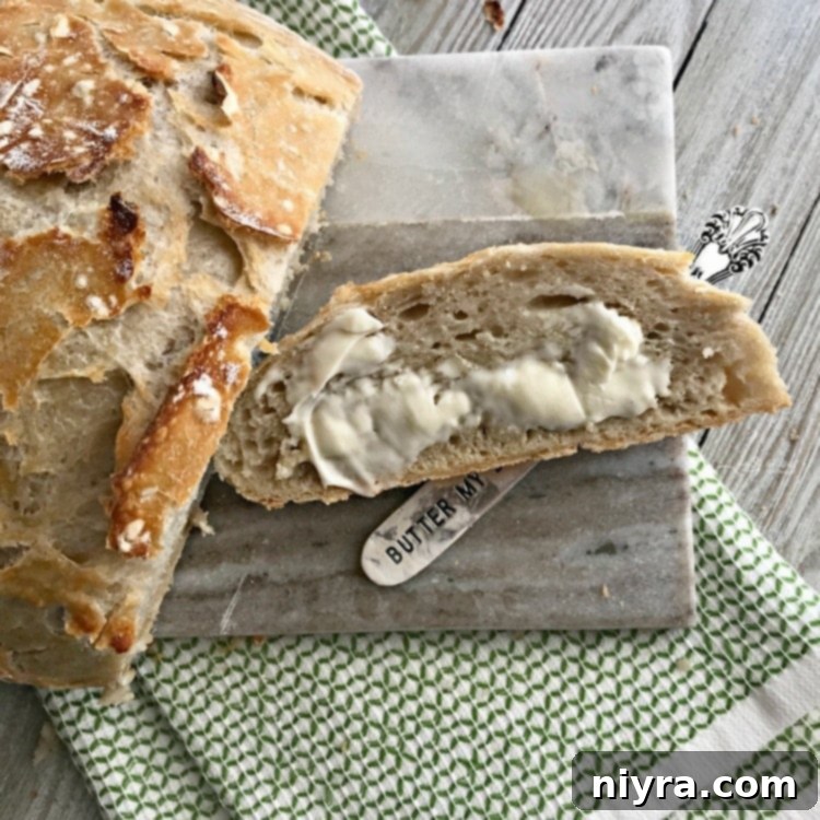 Sliced No-Knead Crusty Dutch Oven Bread with butter