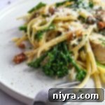 Extreme close up of Chicken Carbonara on a white plate