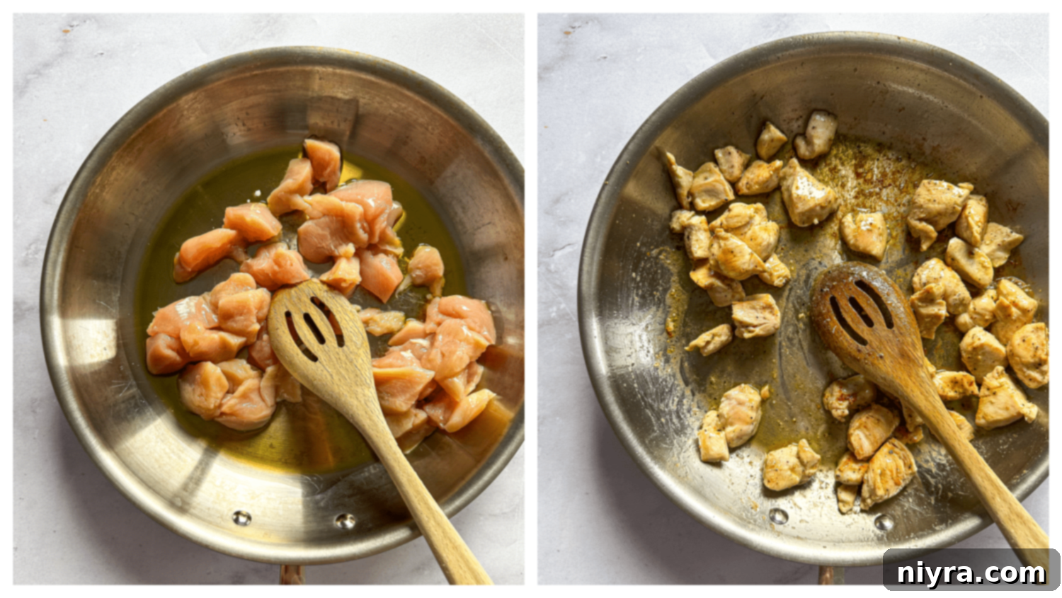 Cubed chicken breasts being cooked in a large skillet with olive oil until golden brown.