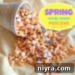 spring candy coated popcorn falling out of a white popcorn bowl on to white cloth. text "Spring Candy coated popcorn"