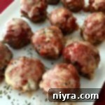 Cheesy Pizza Meatloaf Bites 2 mini meatloaves on a white platter with text "Pizza Meatloaf Minis"