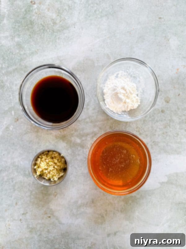 Close-up of golden honey in a glass jar, key ingredient for the sweet sauce.
