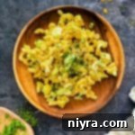 Mom's Macaroni salad on a wooden plate.