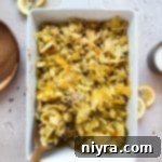 Scooping the Tuna Tetrazzini out of the casserole dish.