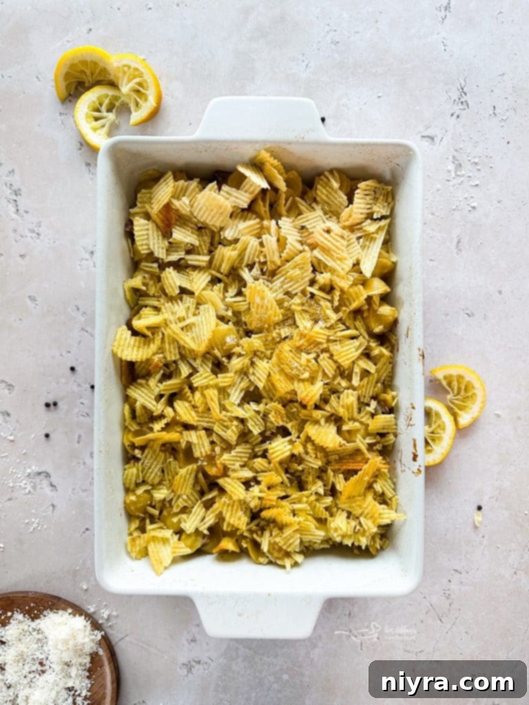 Tuna Tetrazzini Casserole topped with crushed potato chips, ready for the oven.