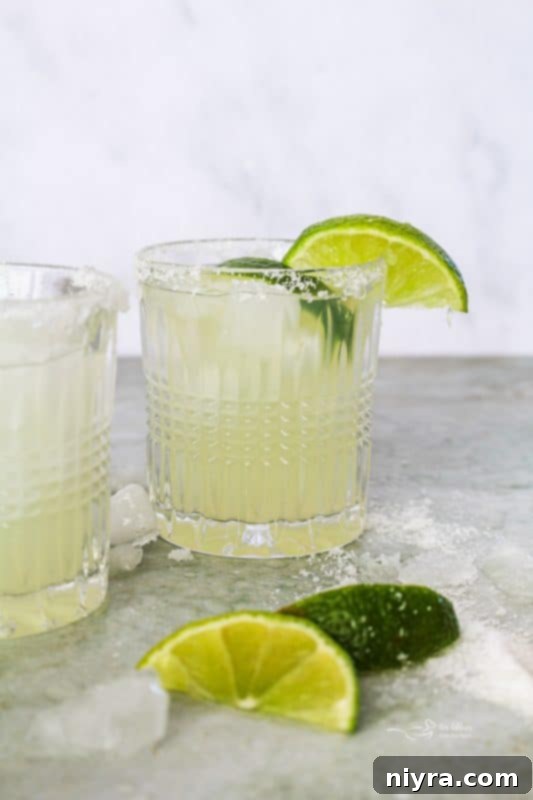 Classic El Bee's Margarita in a glass with a lime wedge