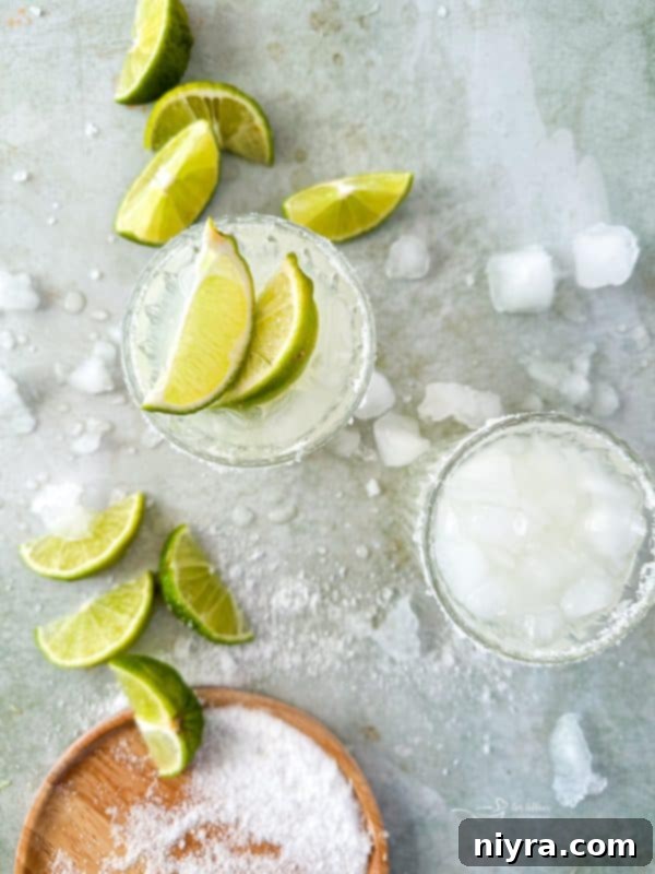 Two glasses of Copy Cat El Bee's Margaritas with limes