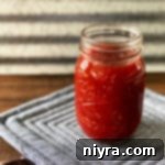 Jar of Homemade Barbecue Sauce on a grey potholder