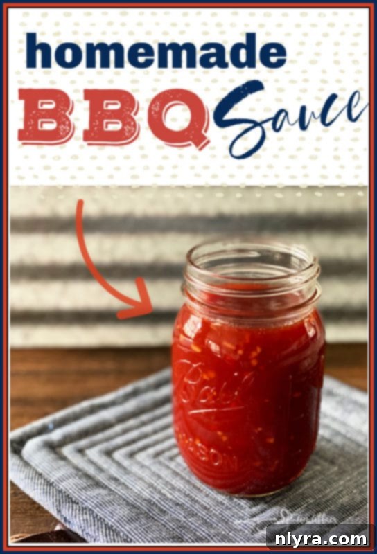 Homemade BBQ sauce in a glass jar with a metal lid, placed on a white cloth on a wooden table.