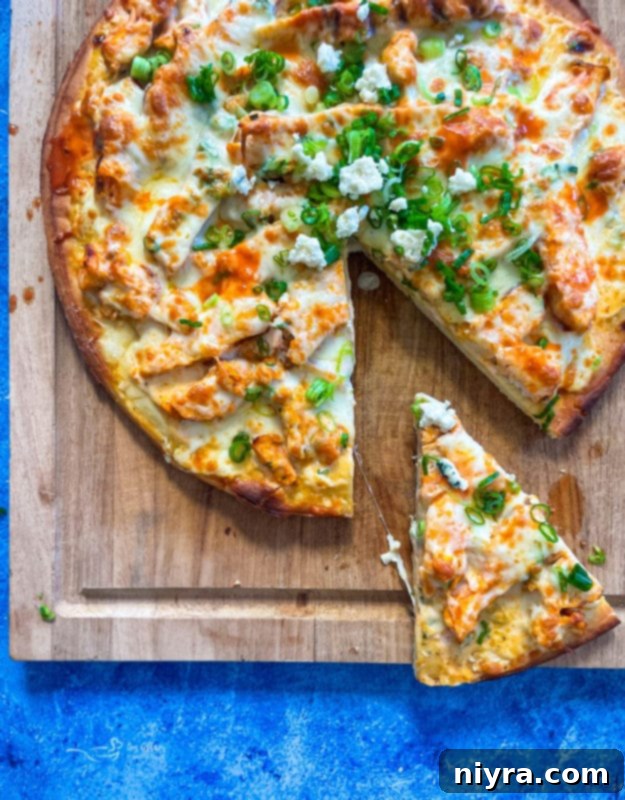 Delicious buffalo chicken pizza slices on a wooden board