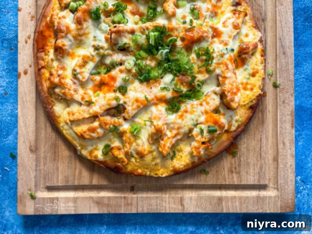 Freshly baked buffalo chicken pizza sliced and ready to eat