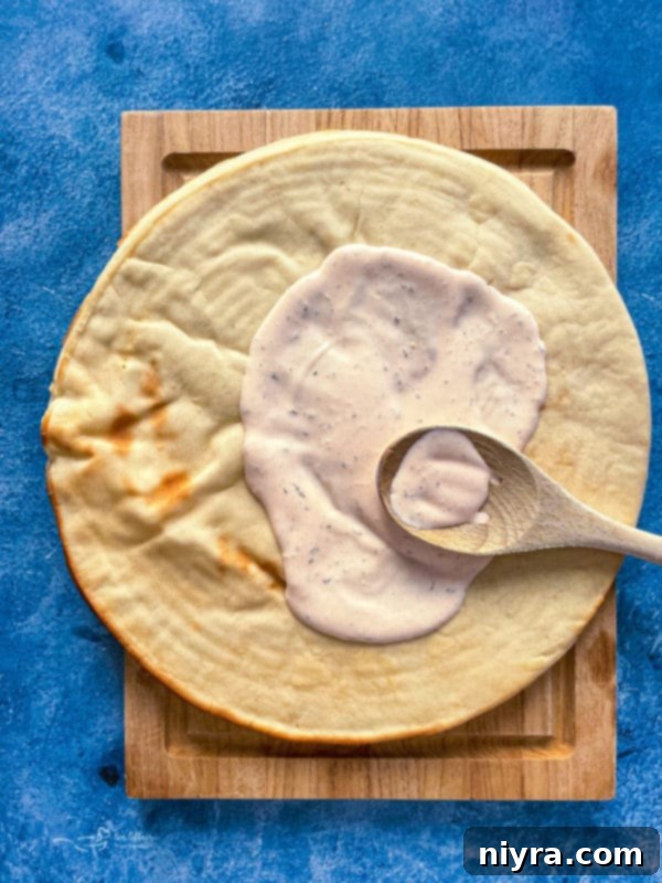 Mixing ranch dressing and hot wing sauce for the pizza base