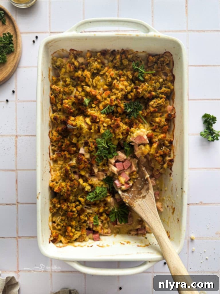 Ham and Swiss Chicken Bake 2 A top-down shot of a golden-brown Chicken Cordon Bleu Casserole in a white baking dish, ready to be served.