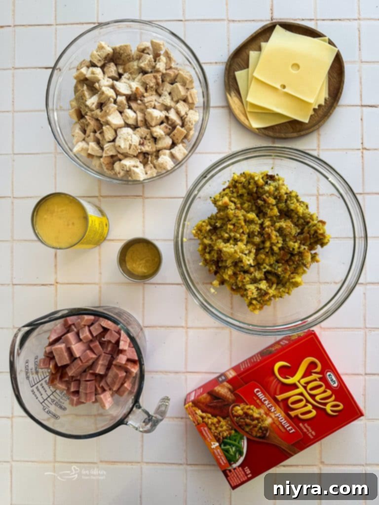 Ham and Swiss Chicken Bake 4 All the ingredients for Chicken Cordon Bleu Casserole laid out on a kitchen counter: stuffing mix, cream of chicken soup, Dijon mustard, cooked chicken, diced ham, and Swiss cheese slices.