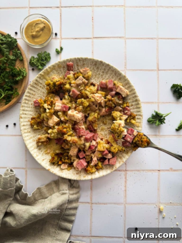 Ham and Swiss Chicken Bake 5 A baking dish filled with the chicken and ham mixture, topped with Swiss cheese slices, before the stuffing is added.