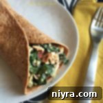 Delicious Chicken Caesar Club Wrap on a white plate