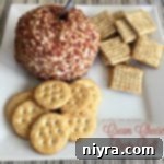 Festive Cream Cheese Ball 2 Close up of Cream Cheese Party Ball and crackers on a white plate