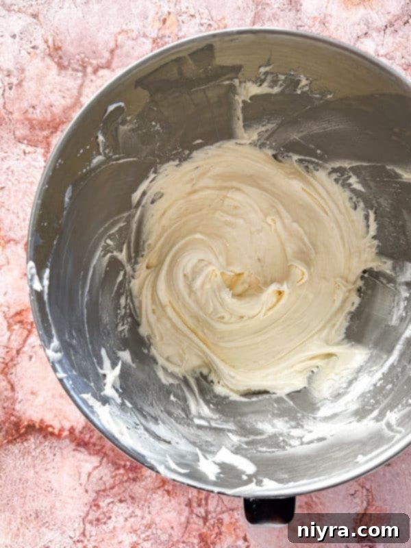 Cinderella Pumpkin Bundt Cake with Cream Cheese Frosting 12 Baked Pumpkin Bundt Cake cooling on a wire rack after being inverted from the pan