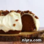 Cinderella Pumpkin Bundt Cake with Cream Cheese Frosting 19 Pumpkin Bundt Cake with Cream Cheese Frosting (Cinderella Cake) on a wooden serving plate