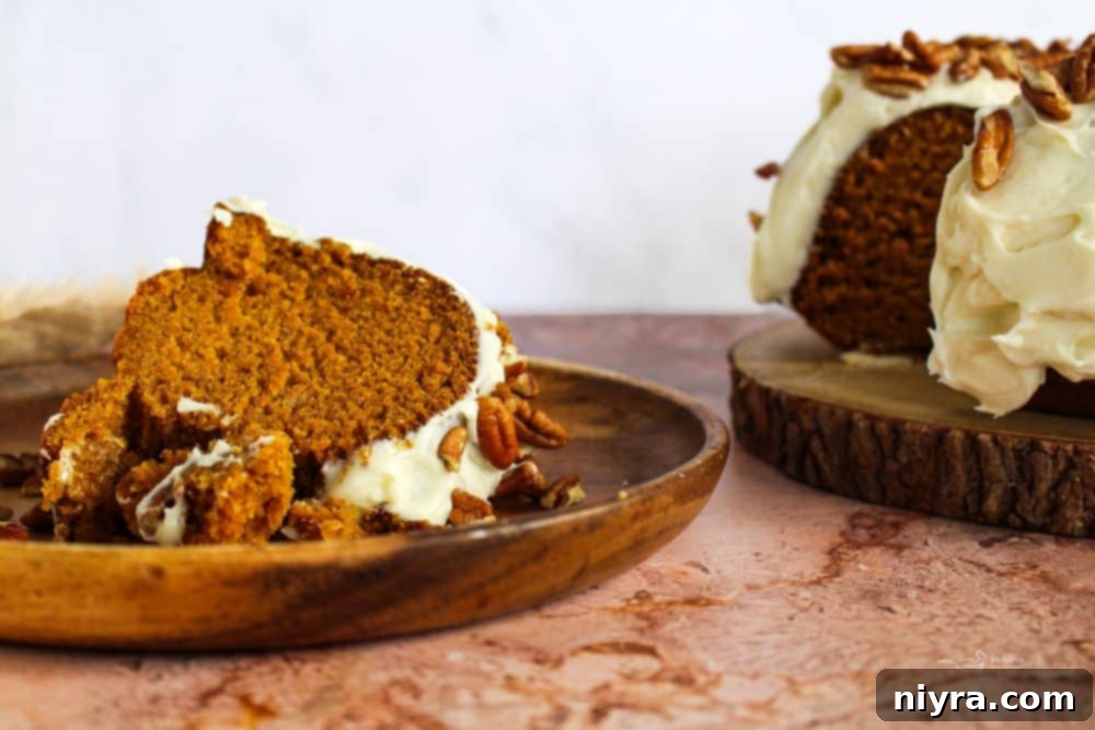 Cinderella Pumpkin Bundt Cake with Cream Cheese Frosting 3 Full Pumpkin Bundt Cake with Cream Cheese Frosting on a rustic wooden board