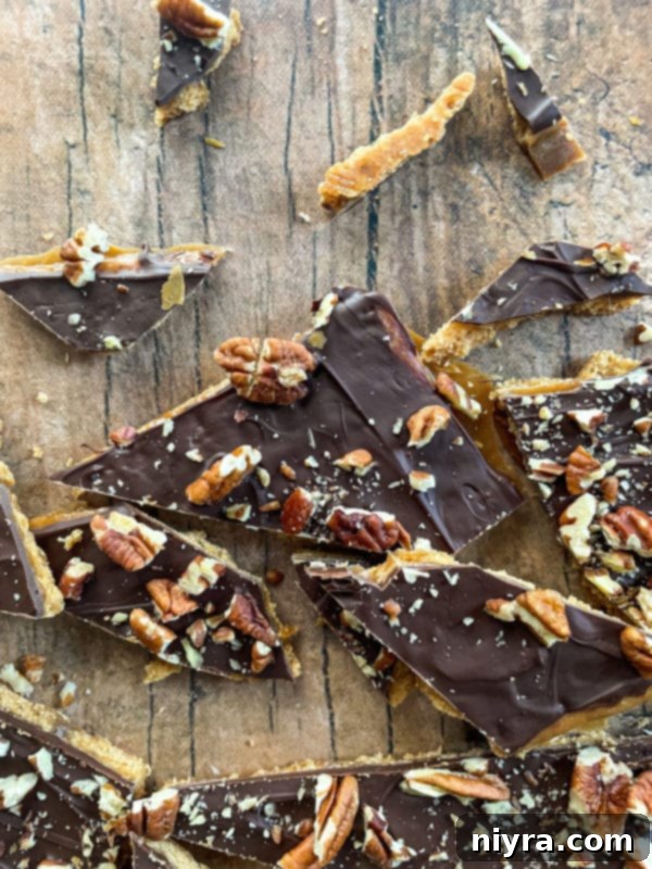 Broken pieces of homemade graham cracker toffee, showcasing the rich texture and delicious layers.