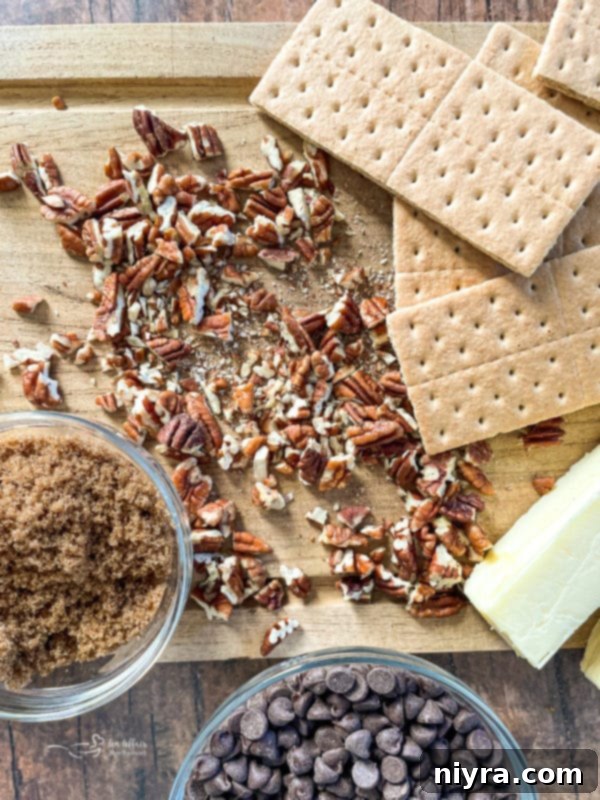 Essential ingredients for Graham Cracker Toffee: graham crackers, pecans, brown sugar, butter, and chocolate chips.