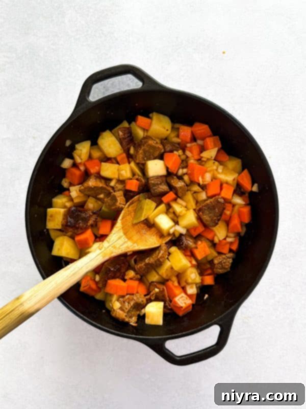 Finished Mulligan Stew in a Dutch oven, ready to be served, rich with vegetables and beef.