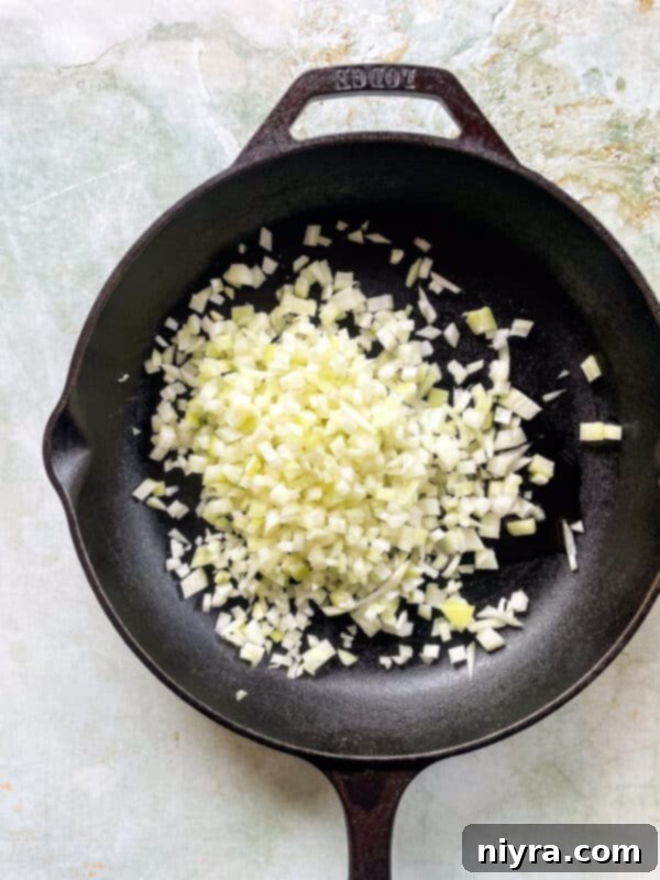 Step 1: Cooking diced onions in a skillet.