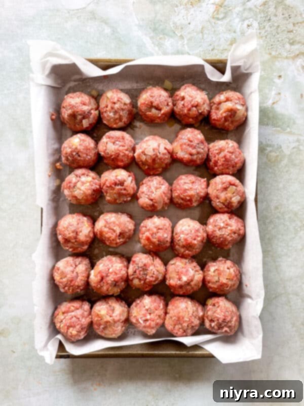 Step 3: Rolling meatball mixture into uniform balls.