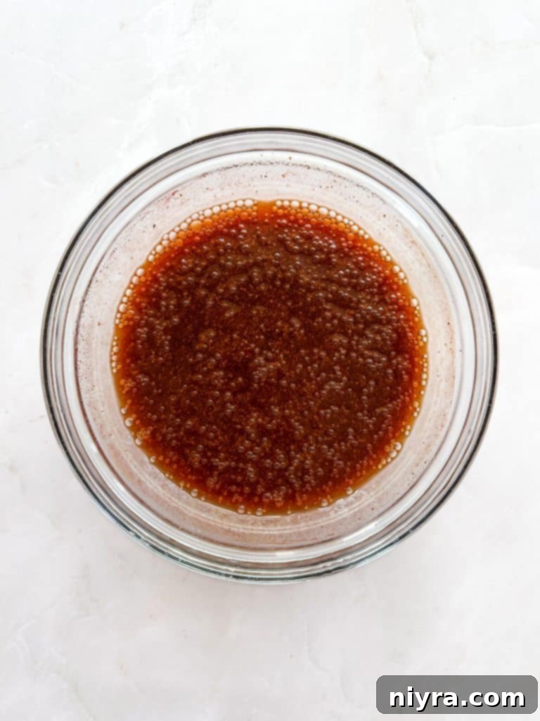 Cooked Dr. Pepper Ribs resting on a wire rack over a baking sheet.