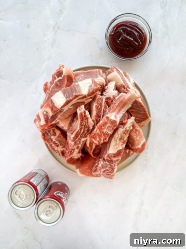 Two hands brushing BBQ sauce onto Dr. Pepper Ribs on a baking rack.