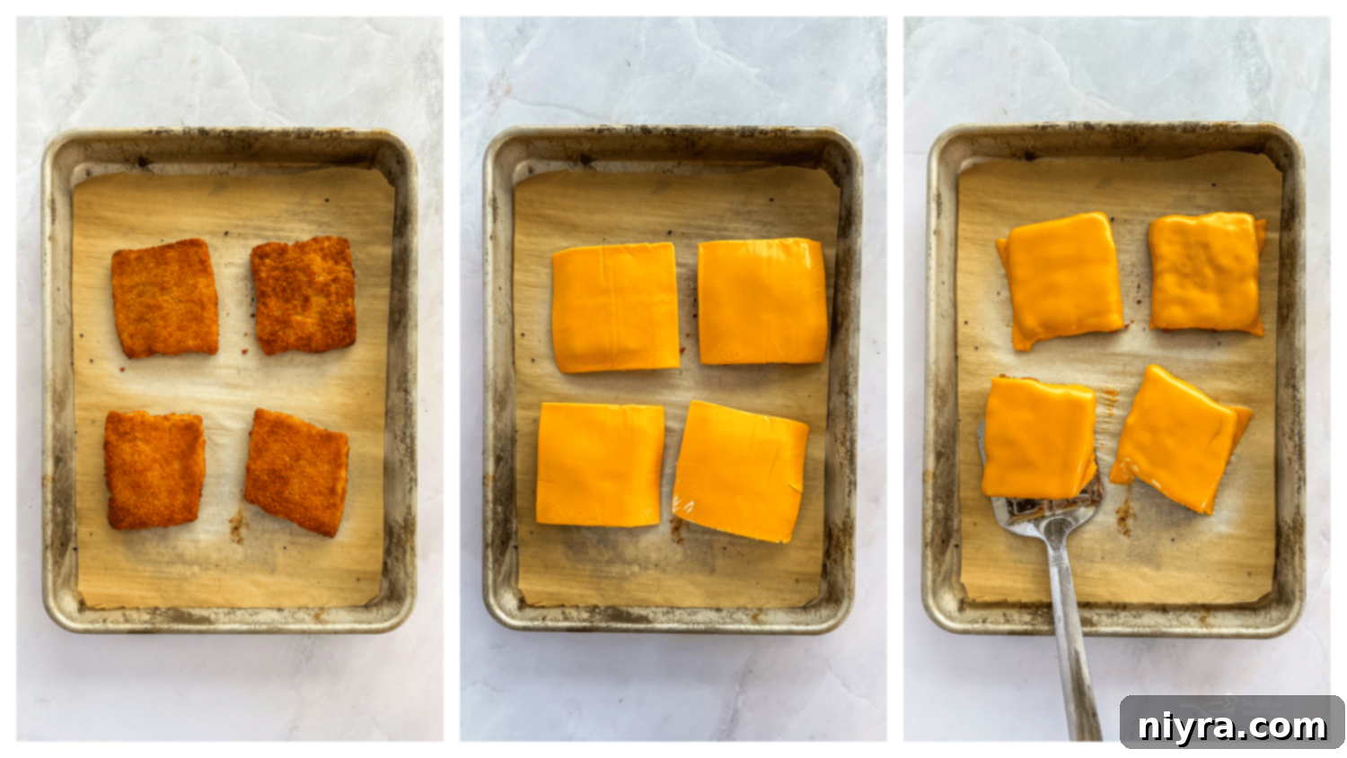 Breaded fish patties baking on a sheet pan in the oven.
