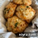 Five cheddar bay biscuits in basket