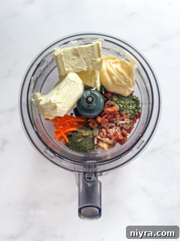 The food processor with ingredients for the sandwich spread, ready to be pulsed.