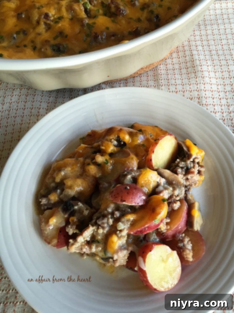 Close-up of a bubbling Sausage & Potato Casserole with melted cheese