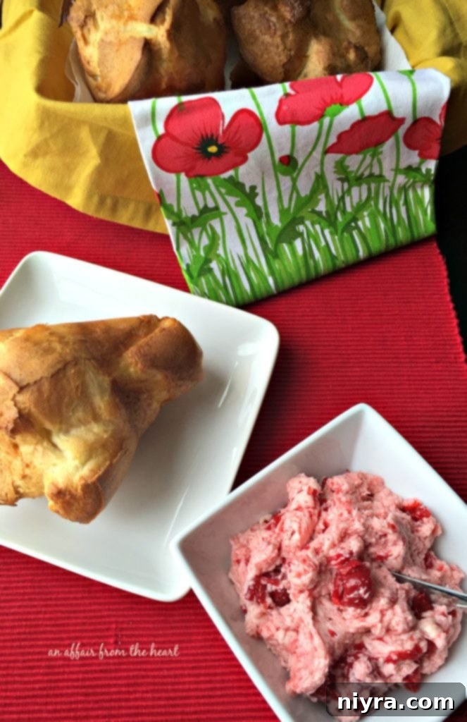 Golden brown Old Fashioned Pop Overs with bright red Cherry Butter