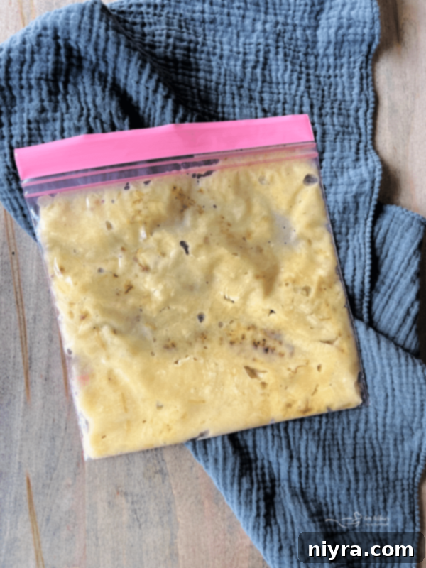 Mashed bananas portioned into a freezer bag for storage.