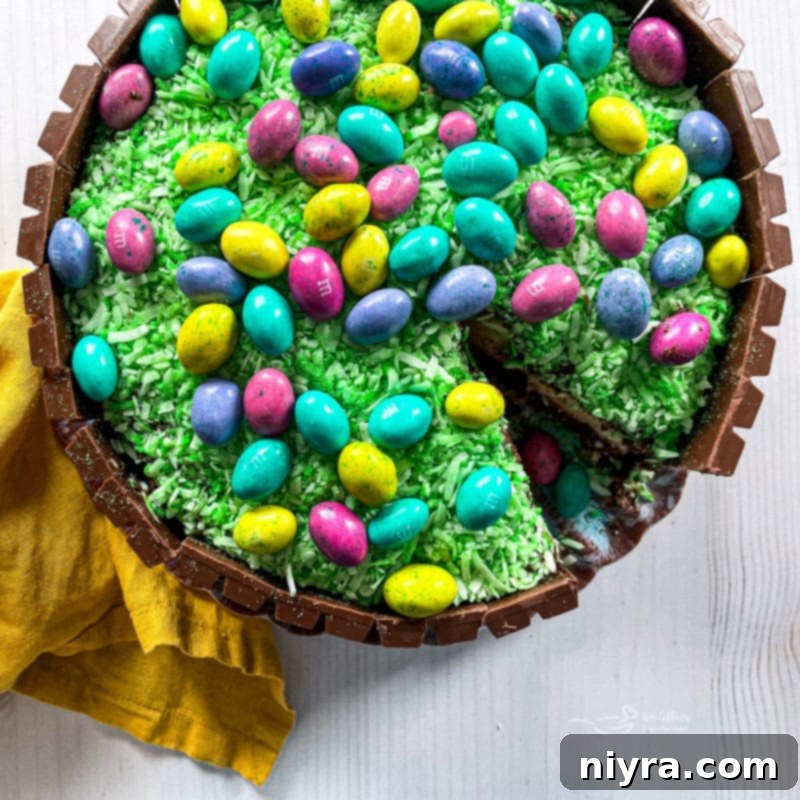 A vibrant Kit Kat Easter Basket Cake, topped with colorful Easter M&M's and a basket handle, ready to delight your guests.