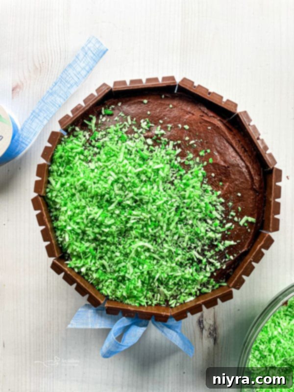 The top of the Easter Kit Kat Cake adorned with vibrant edible Easter grass, setting the stage for candies.